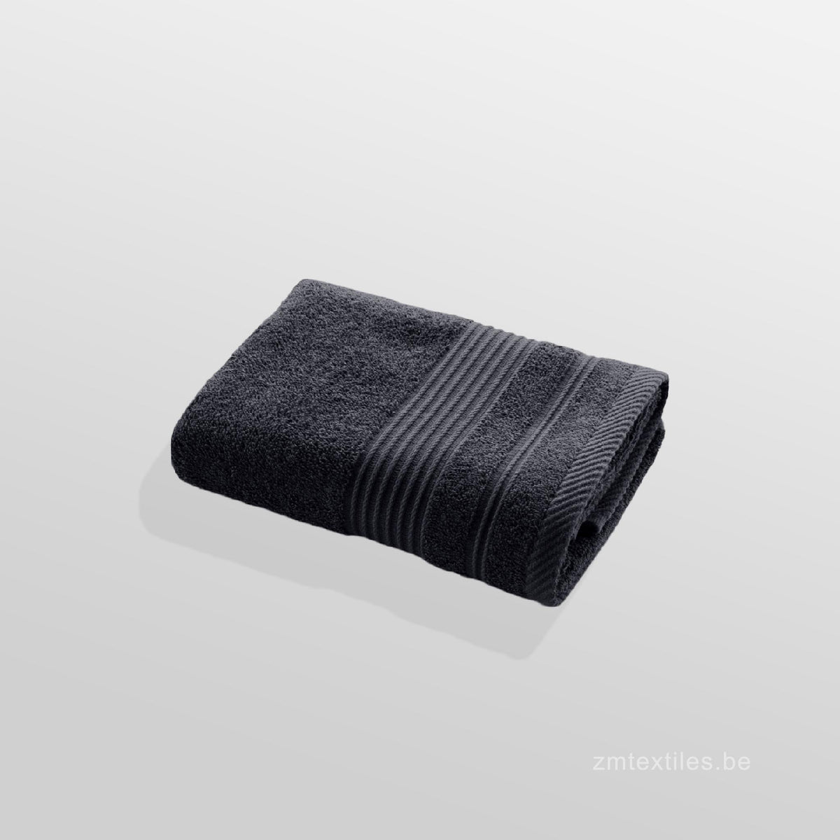 Folded anthracite towel on a light gray background, featuring ZM Textiles Belgium 500GSM Ultra Absorbent Towels.