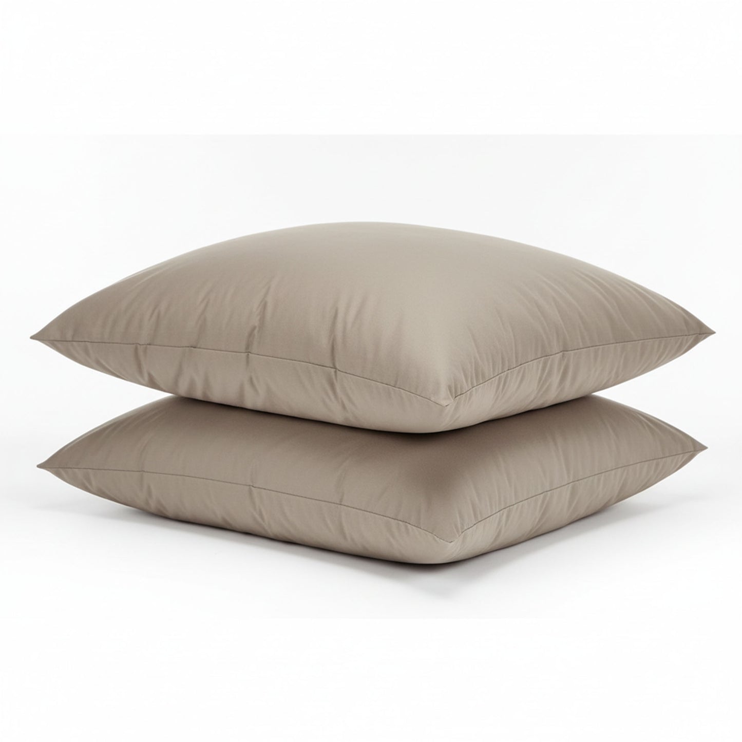 Two beige pillows stacked on a white background, featuring ZM Textiles Belgium dyed pillowcase set.