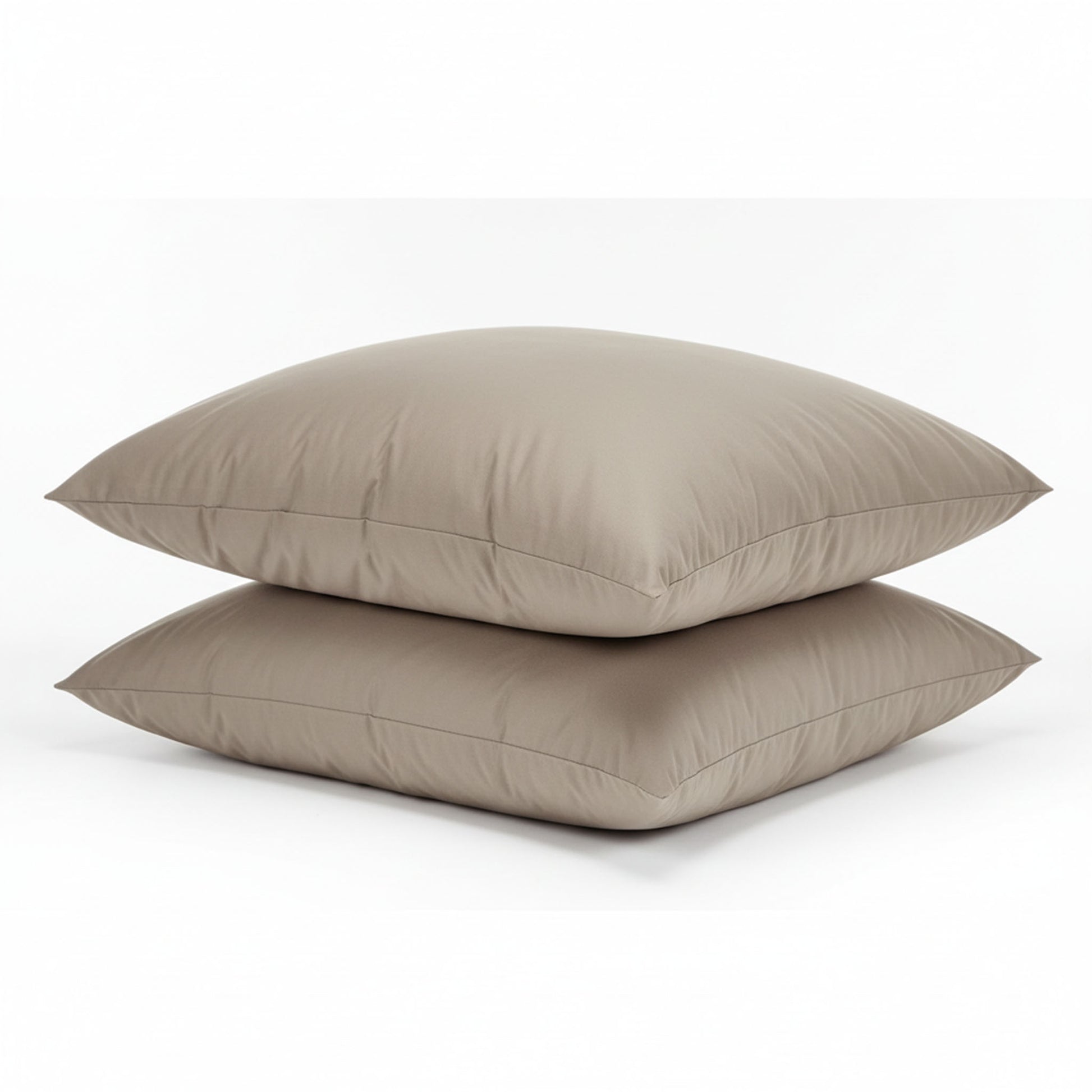 Two beige pillows stacked on a white background, featuring ZM Textiles Belgium dyed pillowcase set.