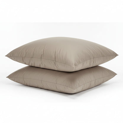 Two beige pillows stacked on a white background, featuring ZM Textiles Belgium dyed pillowcase set.
