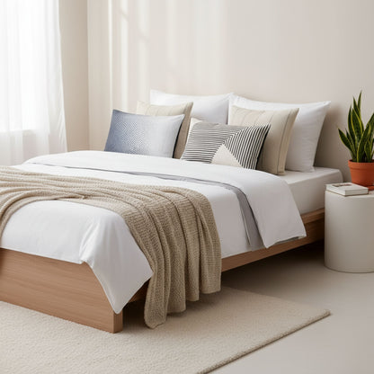 Neatly made bed with pillow cases and a blanket in a bedroom setting, featuring ZM Textiles Belgium printed pillowcase set.