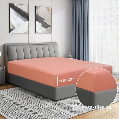 Bed with a fitted sheet showing depth measurement in a bedroom setting. featuring ZM Textiles Belgium T144 Cotton fitted sheets.