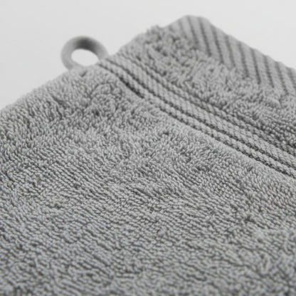 Gray textured wash glove with a circular hole, likely for hanging, featuring ZM Textiles Belgium wash gloves.