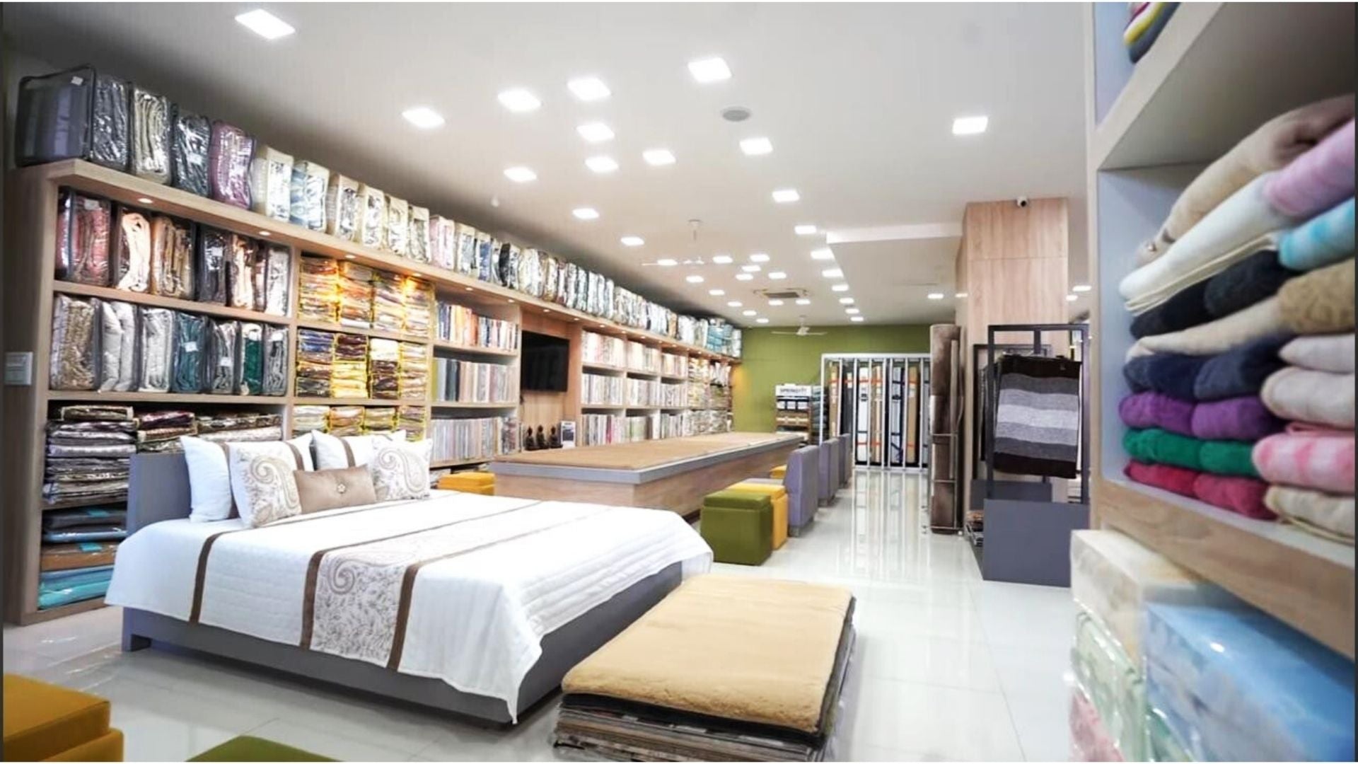 Interior of ZM Textiles store with beds and bedding and towels displayed.